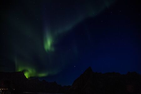 Northern lights above Reine in Lofoten islands in Norwayの写真素材