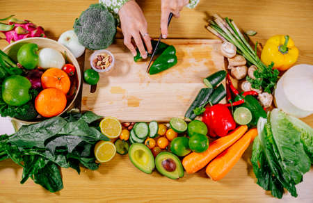 Asian girl cooking healthy vegetarian and vegan food, vegetables and fruits in the kitchen, healthy lifestyleの写真素材