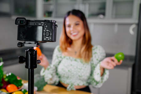 Asian woman blogger or content creator cooking and recording video camera. showing healthy food...