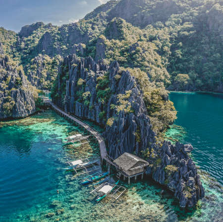 Traditional boats at a wooden pier in Coron island, twin lagoon, Philippinesの写真素材