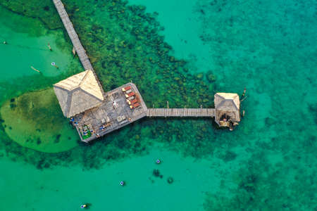 Wooden beach bar in sea and hut on pier in koh Mak island, Trat, Thailand