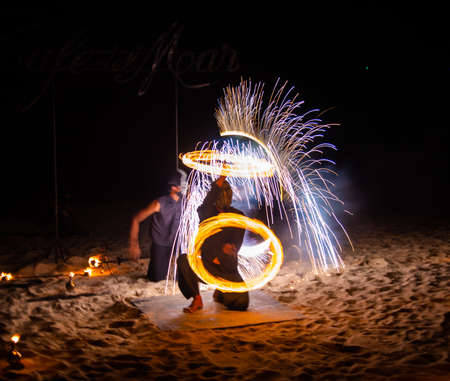 Fire show on the beach at night in Phuket, Thailandの写真素材
