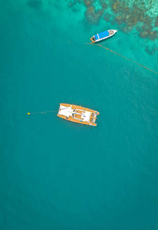 Coral island, koh He, beach and boats in Phuket province, Thailandの写真素材