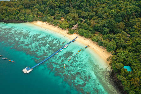 Coral island, koh He, beach and boats in Phuket province, Thailandの写真素材