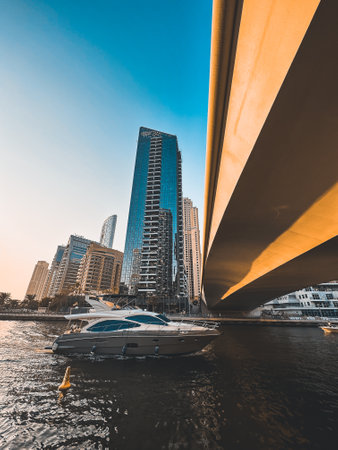 Dubai Marina, harbour, cruise boat and canal promenade view at sunset, in Dubai, United Arab Emiratesの写真素材