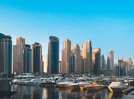 Dubai Marina, harbour, cruise boat and canal promenade view at sunset, in Dubai, United Arab Emiratesの写真素材