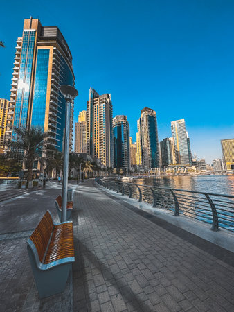 Dubai Marina, harbour, cruise boat and canal promenade view at sunset, in Dubai, United Arab Emiratesの写真素材