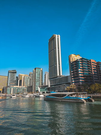 Dubai Marina, harbour, cruise boat and canal promenade view at sunset, in Dubai, United Arab Emiratesの写真素材
