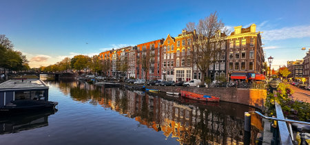 Amsterdam canal view with boats and bicycles at sunset, Netherlandsの写真素材