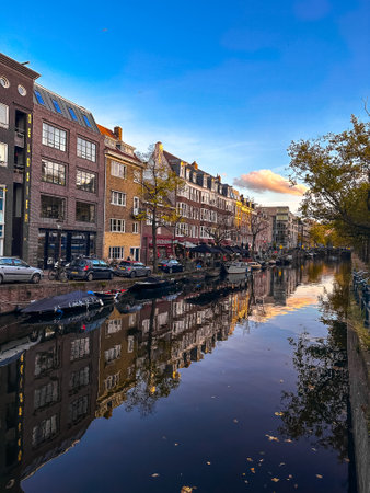 Amsterdam canal view with boats and bicycles at sunset, Netherlandsの写真素材