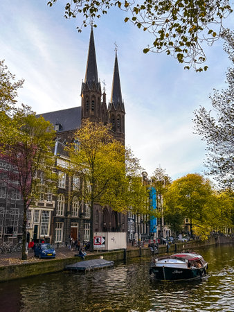 Amsterdam canal view with boats and bicycles at sunset, Netherlandsの写真素材