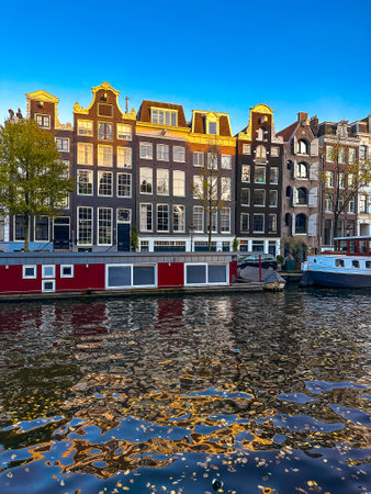 Damrak narrow houses at night in Amsterdam center, Netherlandsの写真素材