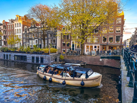 Amsterdam canal view with boats and bicycles at sunset, Netherlands