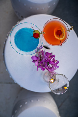 Two cocktails blue and orange at a beach bar in Hua Hin, Thailandの写真素材