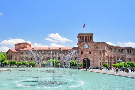 YEREVAN, ARMENIA - MAY, 2016: The fountain on a central square of the city of Yerevan in Armenia. State House and the national flag of Armenia.のeditorial素材