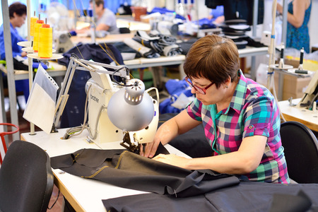 GUKOVO, RUSSIA - SEPTEMBER, 2016: Workers work in a garment factoryのeditorial素材