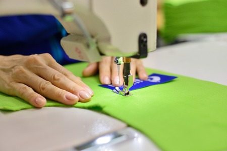 Tailoring Process - Women's hands behind her sewingの写真素材