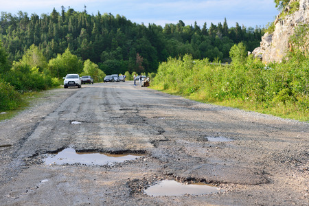 hole in the asphalt, bad road, the risk of movement by carの写真素材