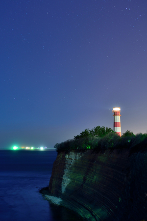 lighthouse and starry night skyの写真素材