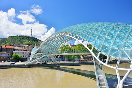 TBILISI, GEORGIA - MAY, 2016: Bridge of Peace in Tbilisi, Geaorgia, bow-shaped pedestrian bridge over the Kura River in Tbilisi, capital of Georgia. One of the most important sites of Tbilisiのeditorial素材