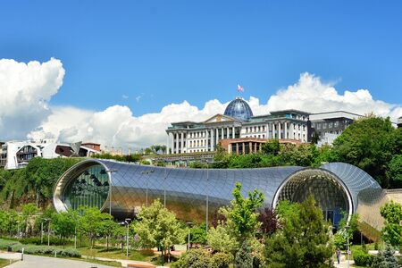 TBILISI, GEORGIA - MAY 2016: People in apark in front of Concert Hall and the Official residence of Georgian President in Tbilisi, Georgiaのeditorial素材