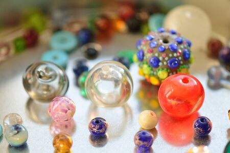 a pile of glass beads of different colors, lampworkの写真素材