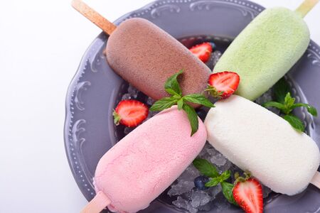 plate with multi-colored ice-cream, fresh berries
