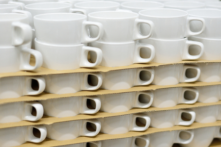 Selling white mugs. The concept of trade in dishes.の写真素材