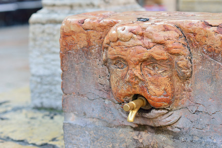 A tap of a drinking fountain in the street of Verona.の写真素材