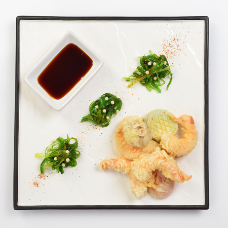 Tempura shrimps and vegetables with soy sauce, deep fried shrimps on white backgroundの写真素材