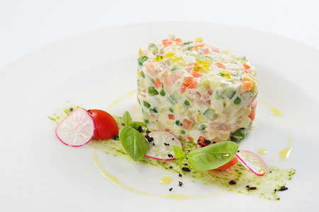 Traditional Russian food, salad olivie with shrimps. White background, menu concept.の写真素材