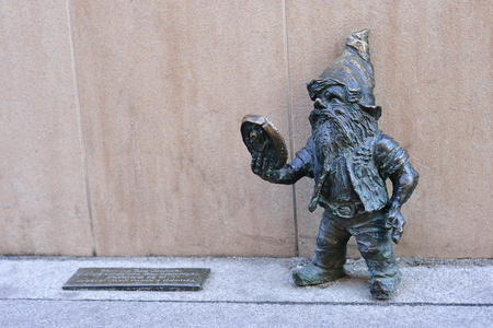 WROCLAW, POLAND - JUNE, 2017: Wroclaw, a miniature statue of a gnome near the beauty salon. A dwarf with a mirror.のeditorial素材