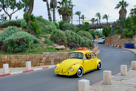 TEL AVIV, ISRAEL - APRIL, 2017: A company of young people on an old yellow Volkswagen, the old town of Jaffa Tel Avivのeditorial素材