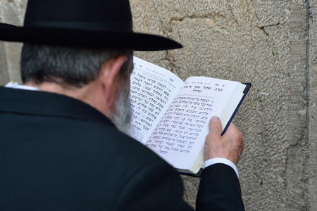 JERUSALEM, ISRAEL - APRIL 2017: Jewish hasidic prayer, the Western Wall, The Wailing Wall of the Place of Weeping is an ancient limestone wall in the Old City of Jerusalem.のeditorial素材