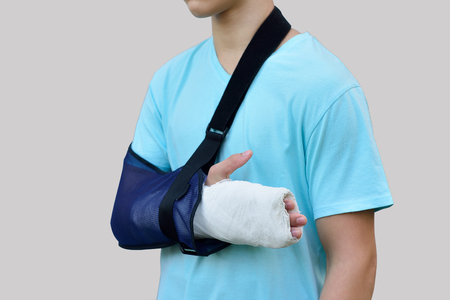 Close up hand with bandage and gypsum as body injury conceptの写真素材