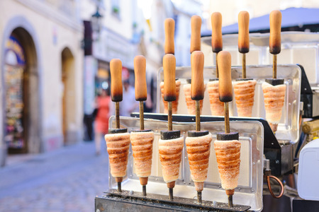 Traditional Czech sweet treat "Trdelnik". To prepare on a special wooden skewers over hot coals. A popular dish among tourists.のeditorial素材
