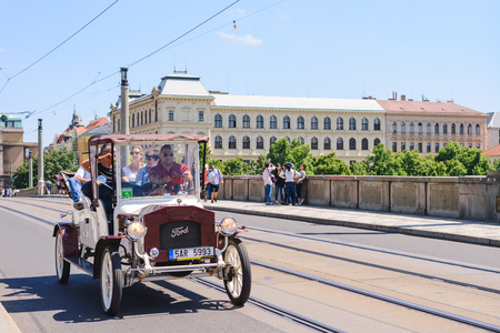 PRAGUE, CZECH REPUBLIC - MAY 2017: Travelers people use service white classic retro car of Czechia people tour around city on the road near Prague castle in Prague, Czech Republicのeditorial素材