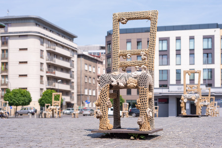KRAKOW, POLAND - JUNE, 2017: Massive chair on cobblestone street in art installation in memory of Jewish ghetto. Krakow with popul. of 800,000 people has 2.35 mill. foreign tourists annuallyのeditorial素材