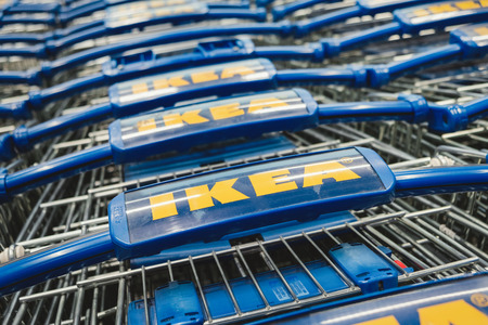 ST. PETERSBURG, RUSSIA - MARCH, 2019: line of Ikea shopping carts. Ikea is a famous Scandinavian chain selling ready-to-assemble furniture, plus housewares, in a warehouseのeditorial素材