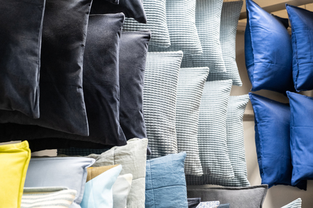 many colorful pillows on shelvesの写真素材