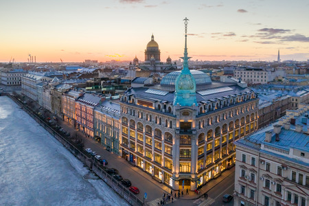 ST. PETERSBURG, RUSSIA - MARCH, 2019: Department store shop class luxury, near the Red Bridge. In the background the city and St. Isaac's Cathedral, in the evening at sunsetのeditorial素材