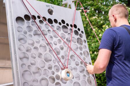 KRAKOW, POLAND - JUNE 17: Museum of Science in the open air. Park. Man tries to bring the balls from...