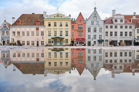 TALLINN, ESTONIA, FEBRUARY 2020: the town hall square in the old town of Tallin, Estonia, reflected in the water.のeditorial素材