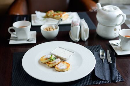 morning Breakfast or brunch in the restaurant. table with drinks and food. cheesecakes with. selective focusの写真素材