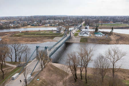 Drone view of the unique chain bridge and St. Nicholas Church in the town of Ostrov, Pskov region.