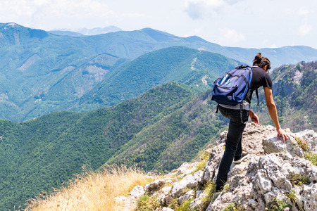 Hiker watching from the peak he reachedのeditorial素材