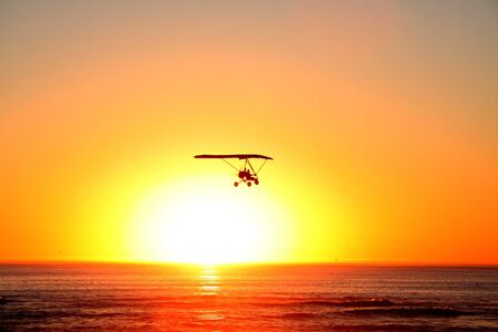 Microlight Airplane and sunset in Swakopmund, Namibiaの写真素材