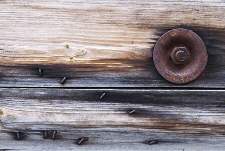 Rusty bolt fastening wooden shieldの写真素材