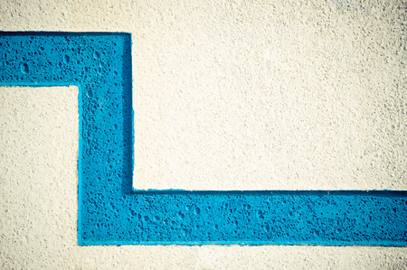 Close-up of the surface of the cement wall, painted with a blue line in zigzagの写真素材