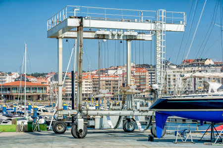 Crane to lifting boats at harbor or marinaのeditorial素材